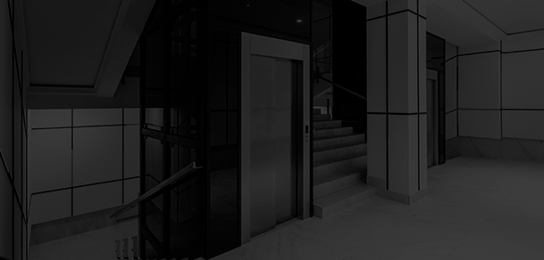 Renovación de cabina de ascensor con diseño minimalista en gris antracita, iluminación LED indirecta y acabados de alta gama para edificios residenciales.